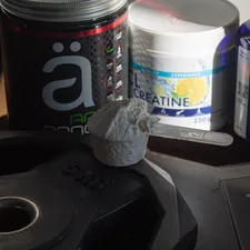 a table topped with bottles of pills and other items related to Benefits of Taking BCAA Before Bed