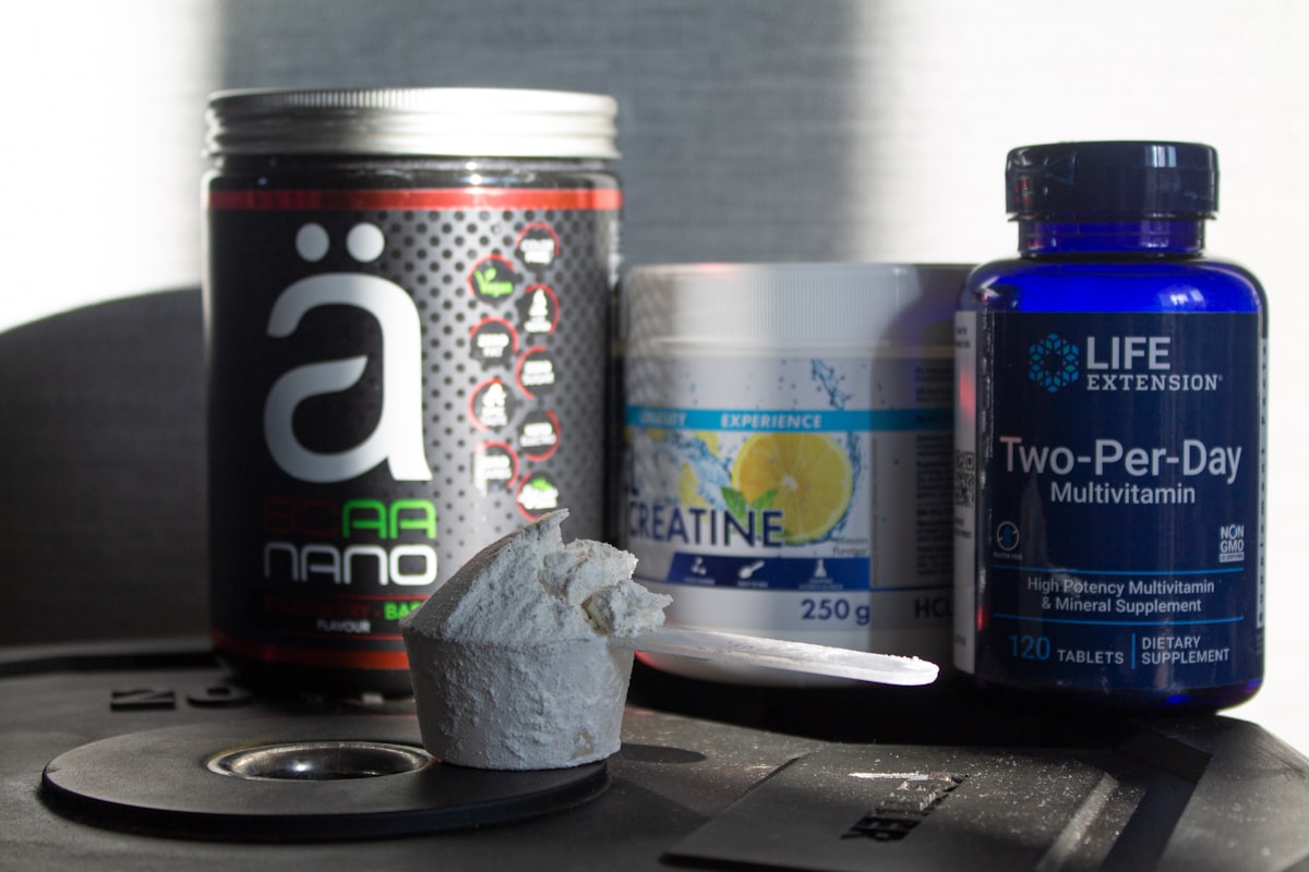 a table topped with bottles of vitamins and pills related to Benefits of Taking BCAA Before Bed