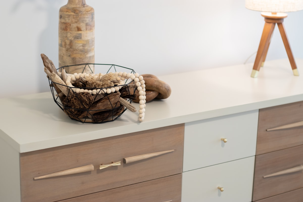 A table with a basket and a lamp on top of it related to Elevate Your Home Decor with Sideboard Buffet Furniture