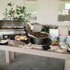 a table with a buffet of food on it related to Timeless Charm: Rustic Buffets and Sideboards for Your Home