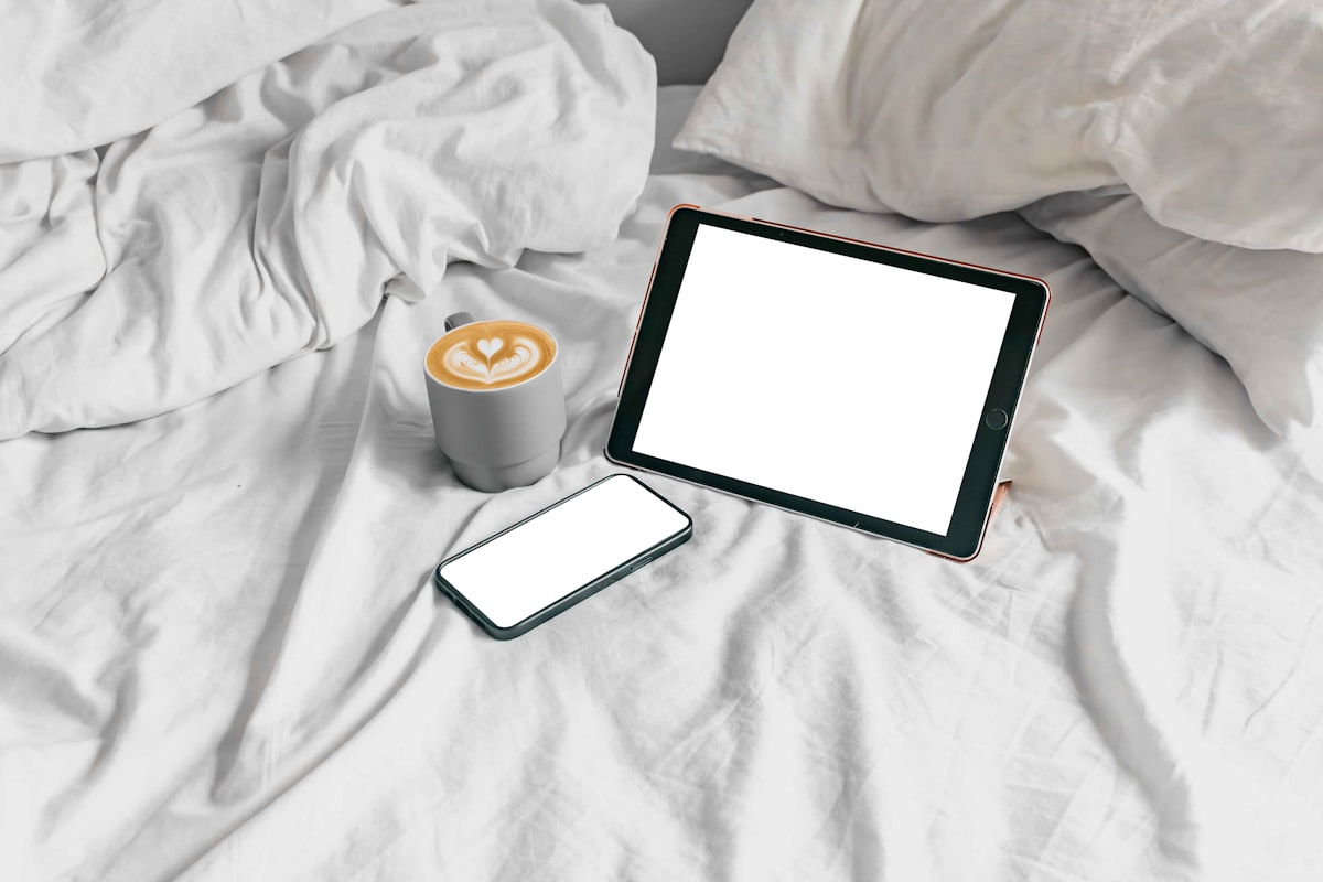a tablet and a cup of coffee on a bed related to Exploring the Bed Bath & Beyond App: A Comprehensive Guide