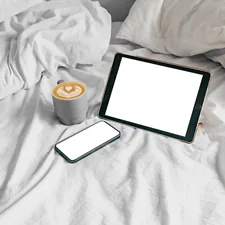 a tablet and a cup of coffee on a bed related to Exploring the Bed Bath & Beyond App: A Comprehensive Guide