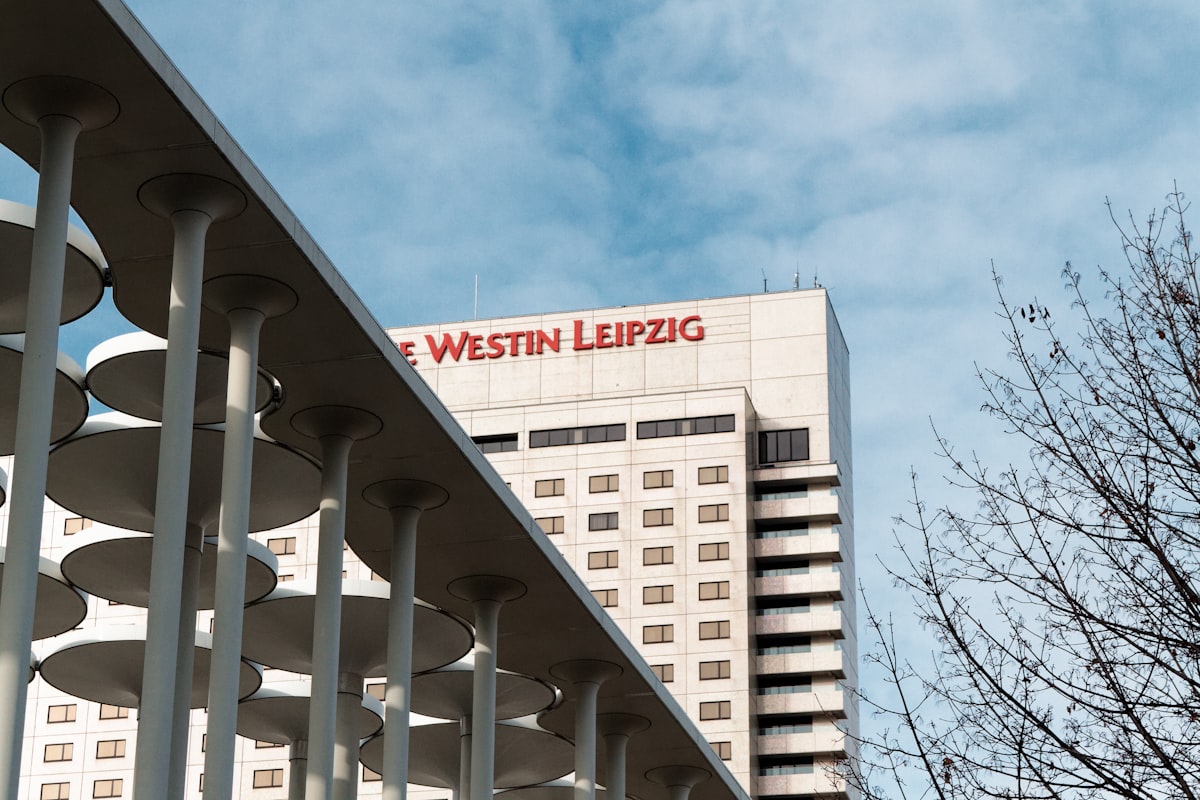 A tall white building with a red sign on top of it related to Unravel the Bliss of Westin Heavenly Bed