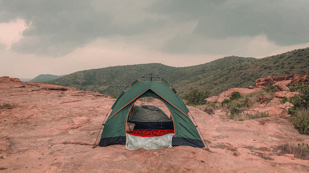 a tent pitched up on a rocky outcropping related to Sleep Under the Stars: Ultimate Guide to Tents for Beds