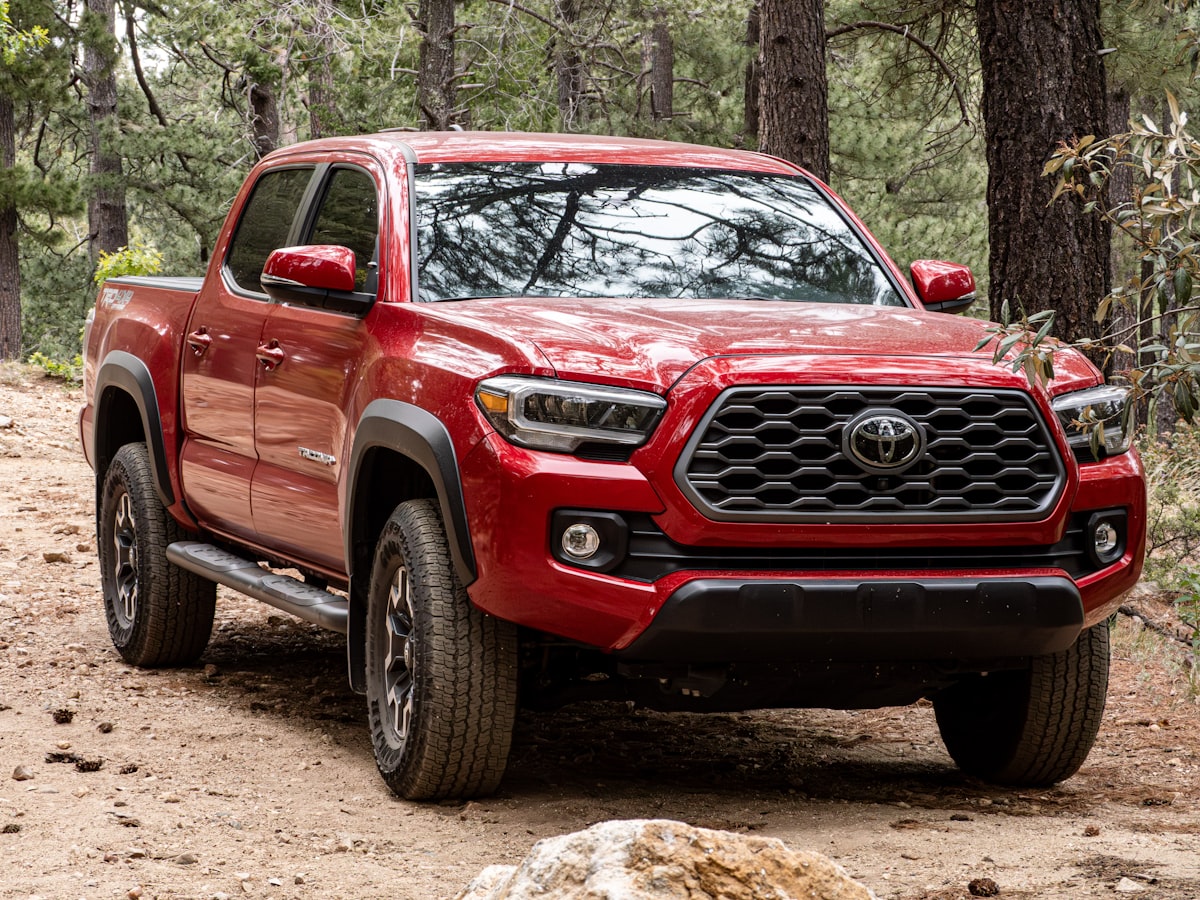 A Toyota Tacoma sitting by trees on the Mt. Lemmon Hiking Trail related to Toyota Tacoma Bed Size Information