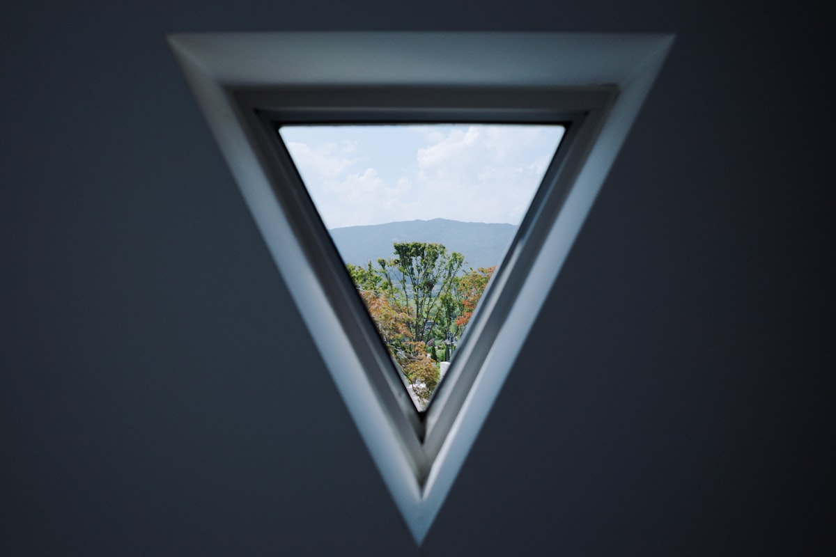 a triangle shaped window with a view of a mountain related to Creative Ideas for Window Valances to Elevate Your Home Decor