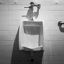 a urinal mounted to a wall in a bathroom related to How to Install a Bidet: A Step-by-Step Guide
