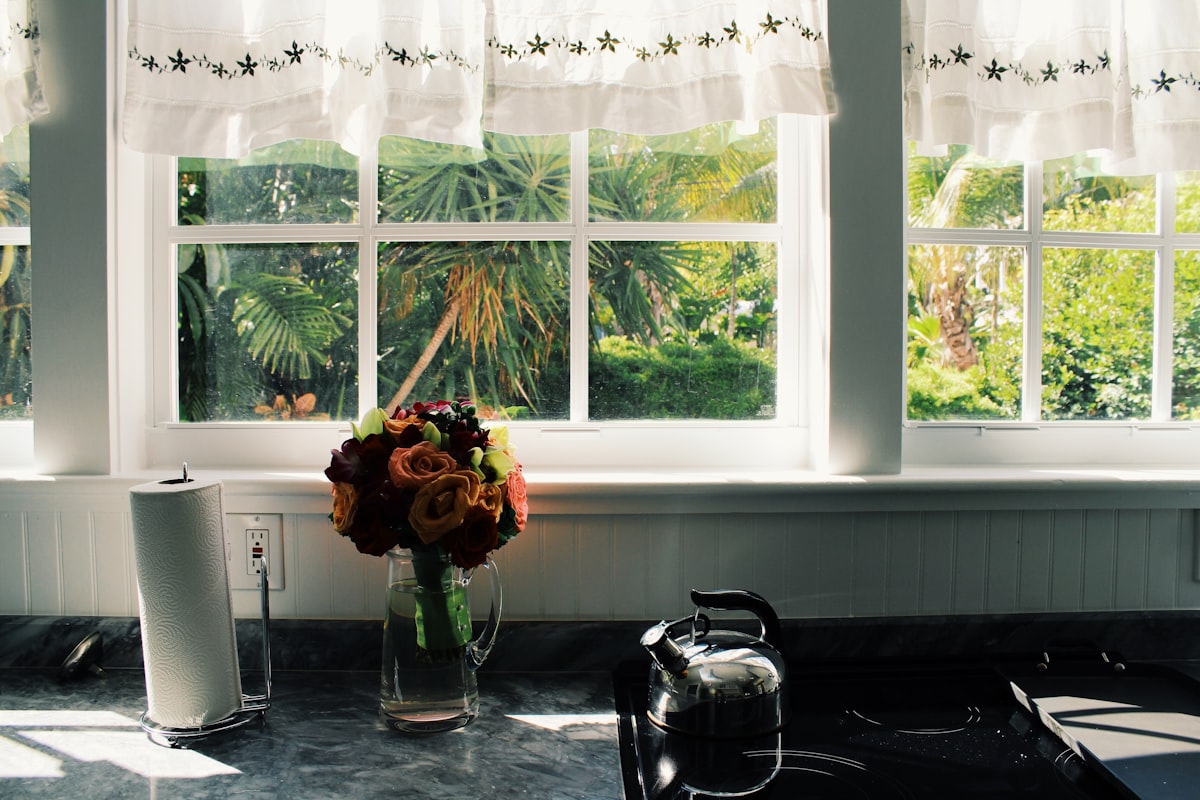 a vase of flowers on a table related to Kitchen Valance Curtains