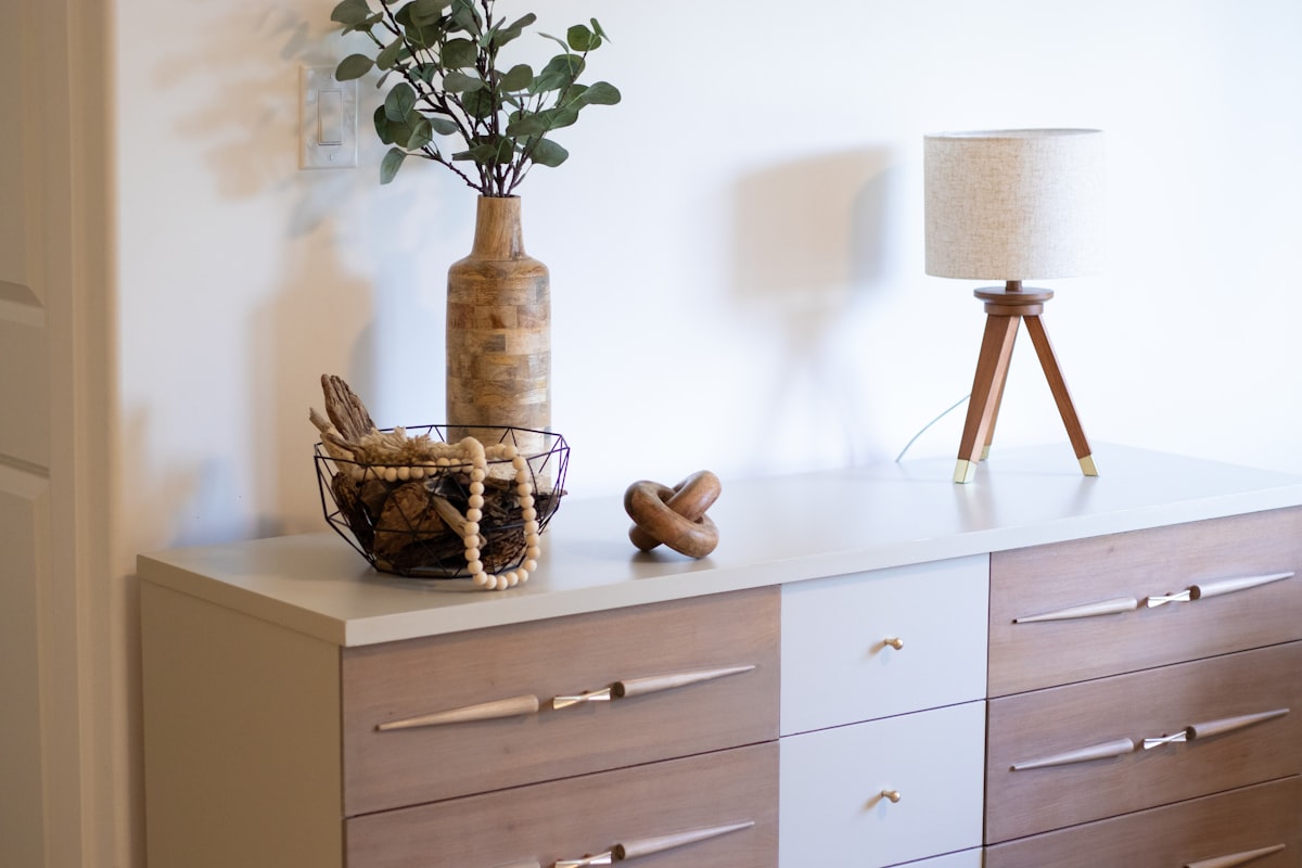 A vase with a plant on top of a dresser related to Elevate Your Home Decor with a Sideboard with Drawers
