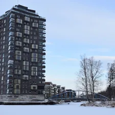 a very tall building sitting next to a bridge related to The Ultimate Guide to Karlstad Sofa Beds: Comfort and Style in One