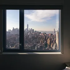 a view of a city from a window related to Transform Your Windows with Custom Made Valances