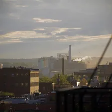 a view of a city with smoke stacks in the distance related to Discover the Charm of Baltimore Bed and Breakfasts: A Cozy Retreat Awaits