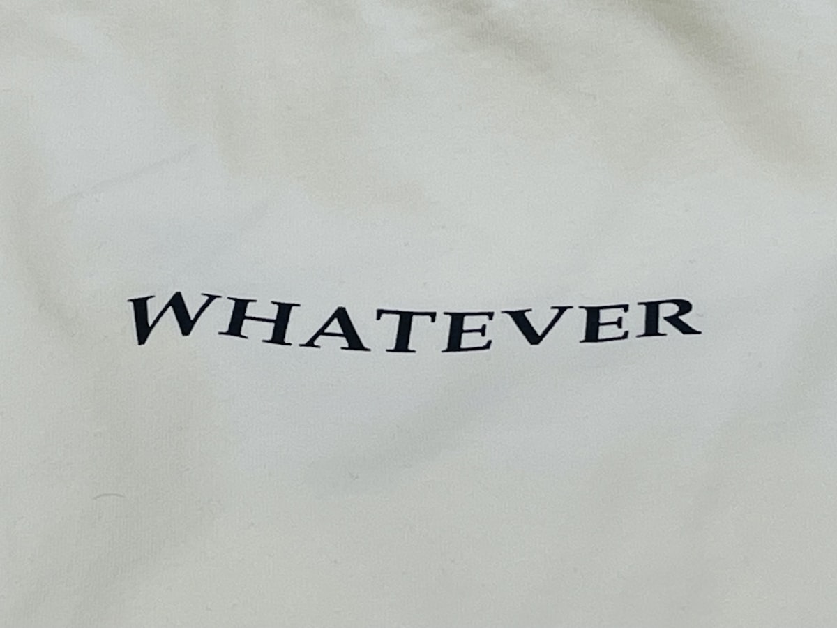 a white bag with the word whatever printed on it related to What is a Bed Coverlet?