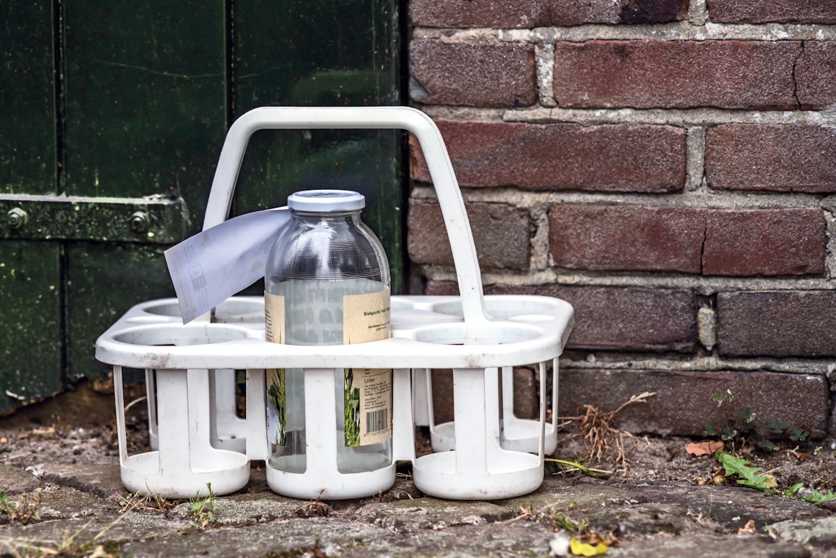a white basket with a bottle on top of it related to Maximize Your Bathroom Space with the Best Shower Caddy from Bed Bath & Beyond