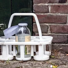 a white basket with a bottle on top of it related to Maximize Your Bathroom Space with the Best Shower Caddy from Bed Bath & Beyond