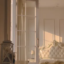 a white bed sitting next to a window in a bedroom related to Sliding Door Valances: Elegant Solutions for Your Space
