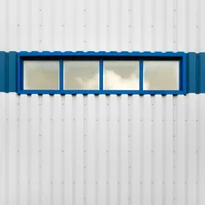 a white building with a blue window on the side of it related to Straight Window Valances