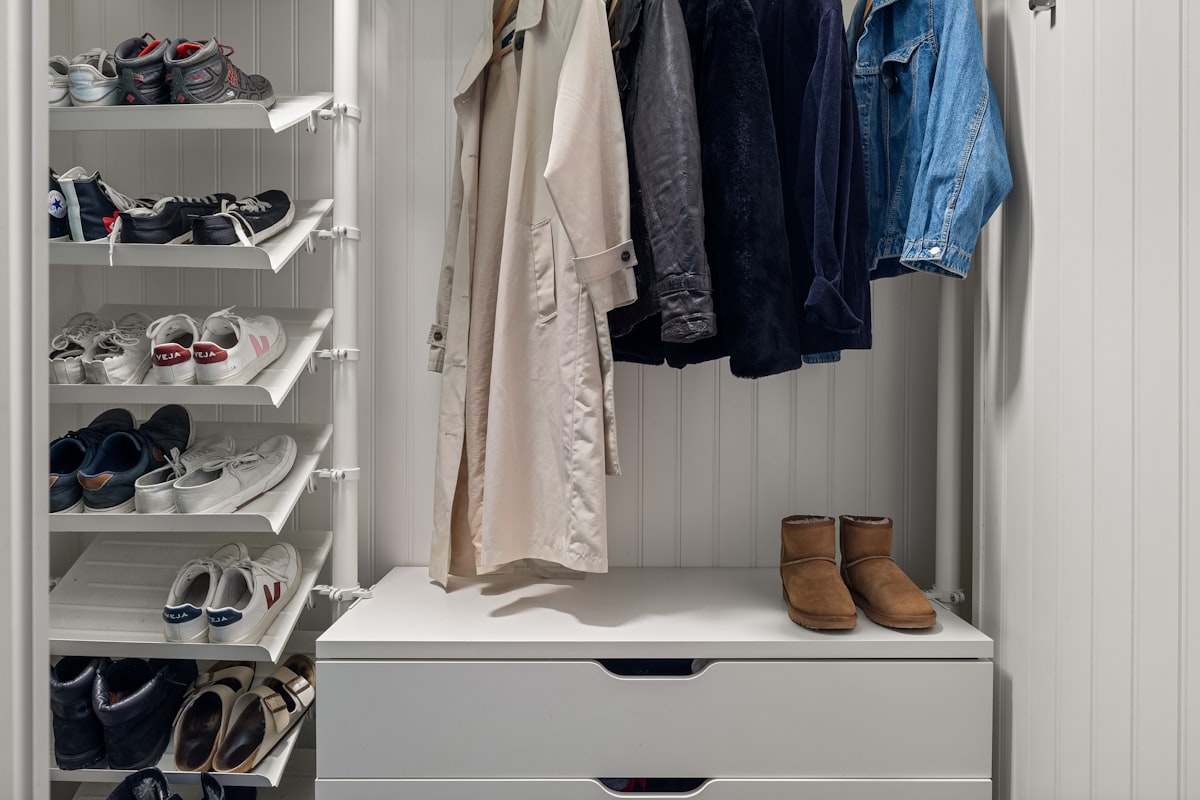 A white closet with shoes and shoes hanging on the wall related to Adding Style and Functionality to Your Windows with Curtains, Valances and Swags