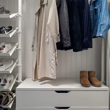 A white closet with shoes and shoes hanging on the wall related to Adding Style and Functionality to Your Windows with Curtains, Valances and Swags