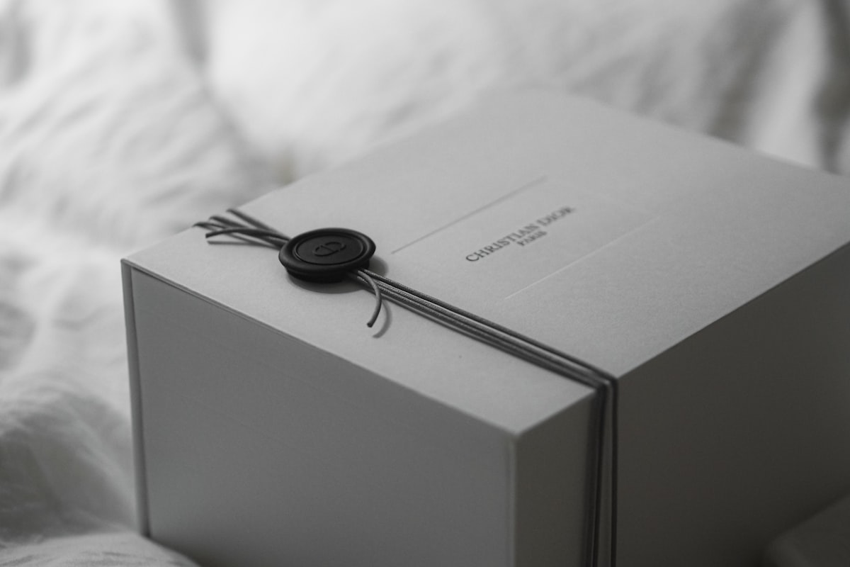 A white gift box tied with ribbon and wax seal. related to Exclusive Limited Edition Sleep Bed: The Ultimate Comfort Experience