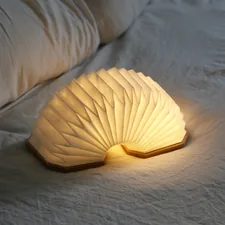 a white lamp sitting on top of a bed related to Exploring the Benefits of Yellow Bed Sheets