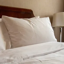 A white pillow in hotel related to Hotel Collection Coverlet