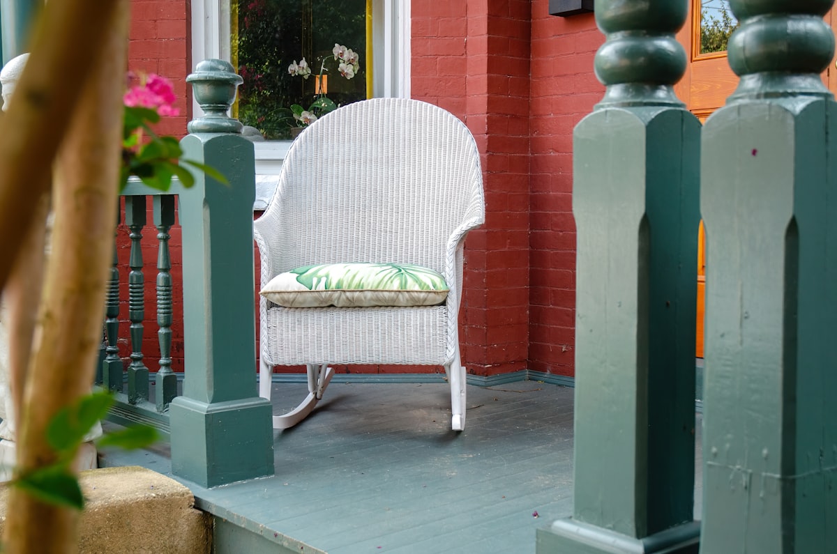 a white rocking chair sitting on a porch related to Cozying Up in Virginia: Top Bed and Breakfast Options