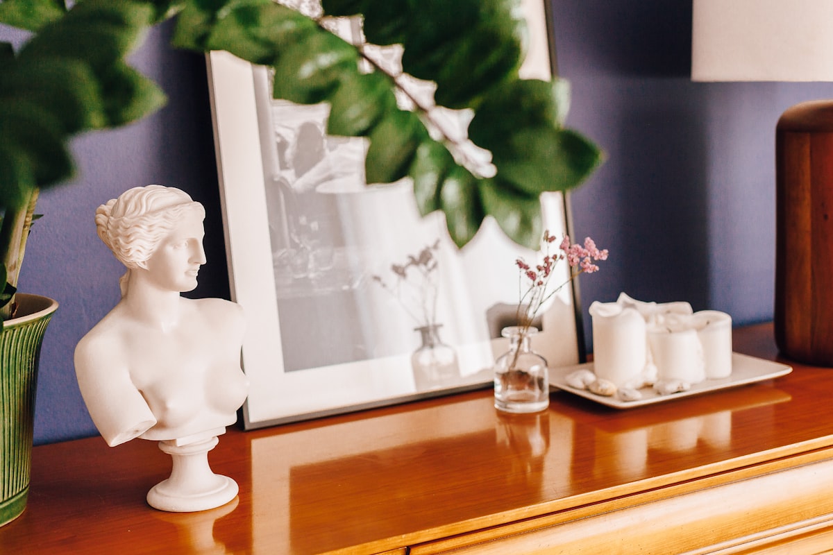 a white statue sitting on top of a wooden dresser related to Elevating Your Home Decor with Modern Valances Window Treatments