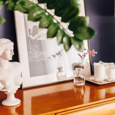 a white statue sitting on top of a wooden dresser related to Elevating Your Home Decor with Modern Valances Window Treatments
