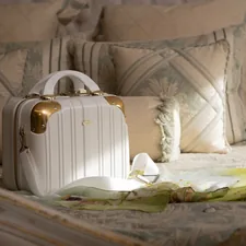 a white suitcase sitting on top of a bed related to Queen-Sized Comfort: The Ultimate Guide to Bed in a Bag Sets