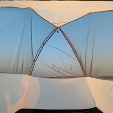 A white tent with a black bag on top of it related to Top Bed Tents for Twin Beds: Cozy Solutions for Kids and Adults