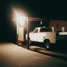 A white truck parked in a parking lot at night related to Transform Your Truck into a Cozy Home: The Ultimate Guide to Truck Bed Trailer Campers