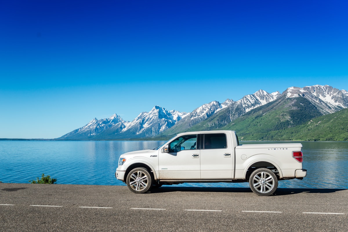 A white truck parked on the side of a road related to Find the Best Truck Bed Covers Near Me: Top Options and Reviews