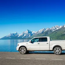 A white truck parked on the side of a road related to Find the Best Truck Bed Covers Near Me: Top Options and Reviews