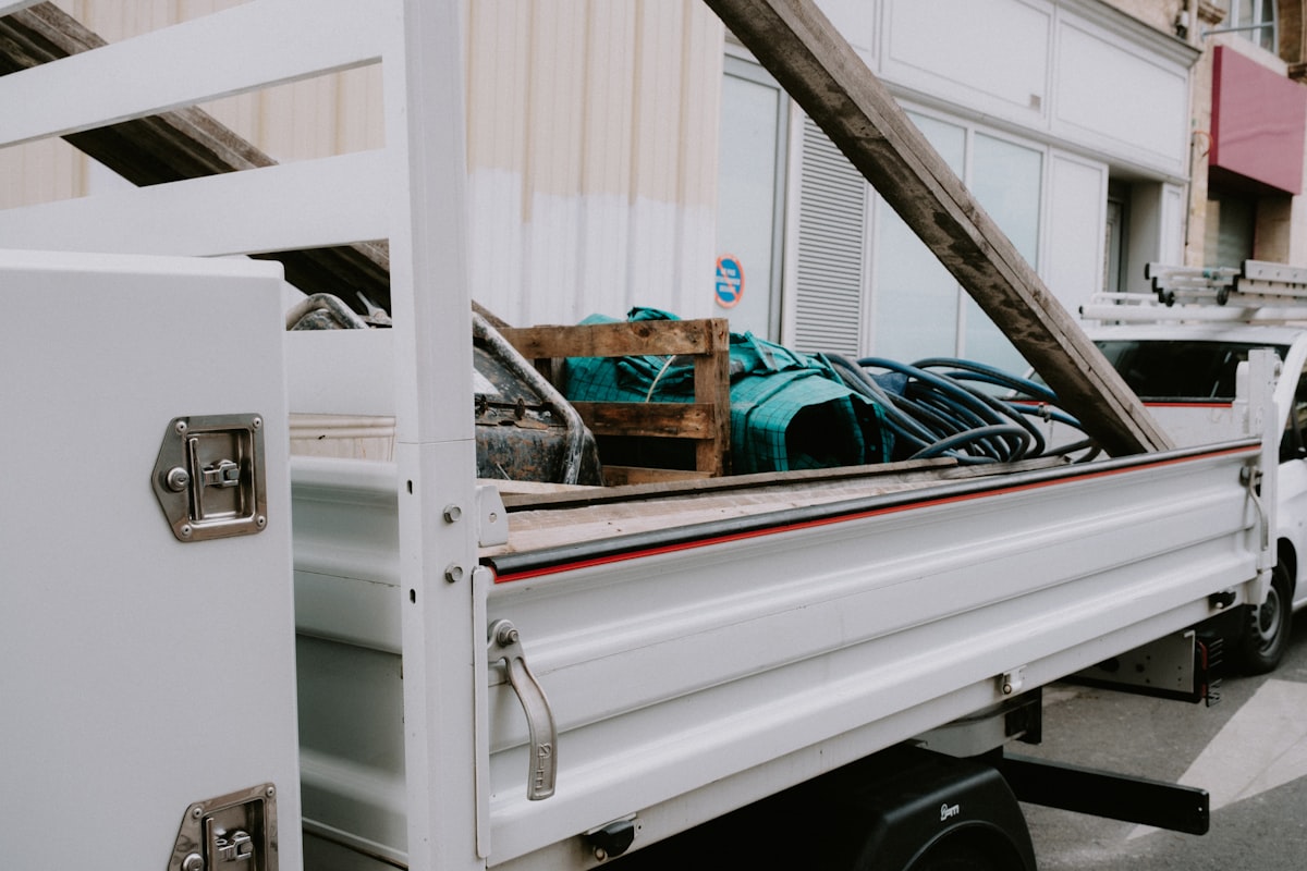 a white truck with a bunch of items in the back related to The Ultimate Guide to Truck Bed Rail Systems