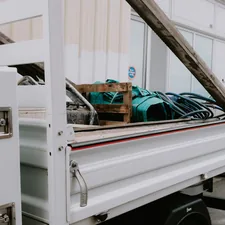 a white truck with a bunch of items in the back related to The Ultimate Guide to Truck Bed Rail Systems
