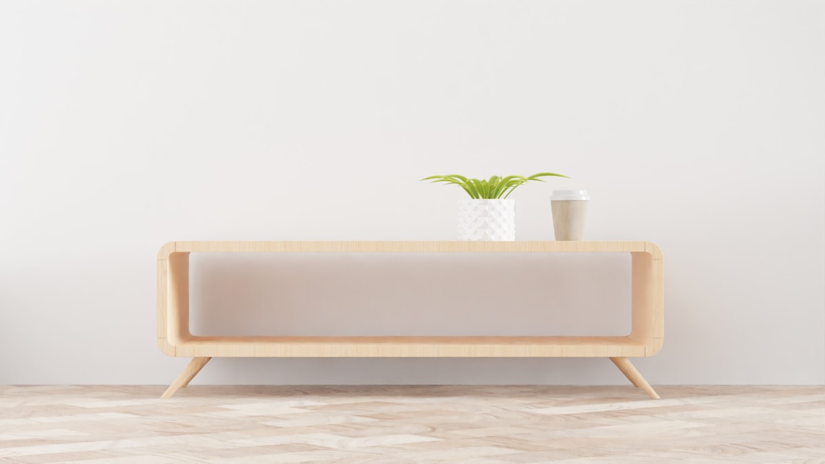a white vase with a green plant on top of it related to Elevate Your Home Decor with Sideboard Buffet Furniture