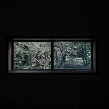 a window in a dark room with trees outside related to Pictures of Window Valances: A Comprehensive Guide