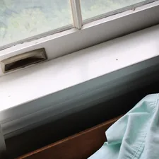 a window sill with a blue shirt on it related to DIY Window Valance: A Step-by-Step Guide