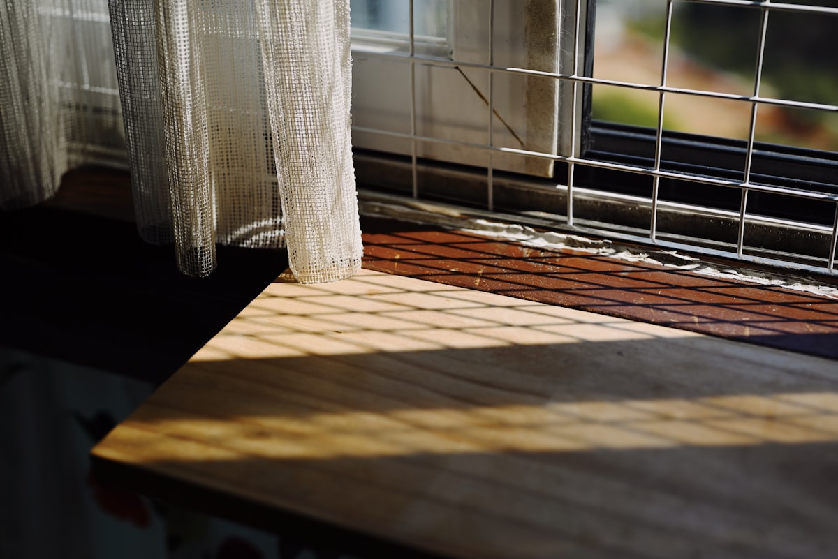 a window sill with a curtain and a window sill in the background related to Faux Wood Valance Ideas for Your Home