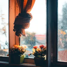 a window sill with flowers in front of it related to Elevate Your Window Decor with a Navy Blue and White Valance