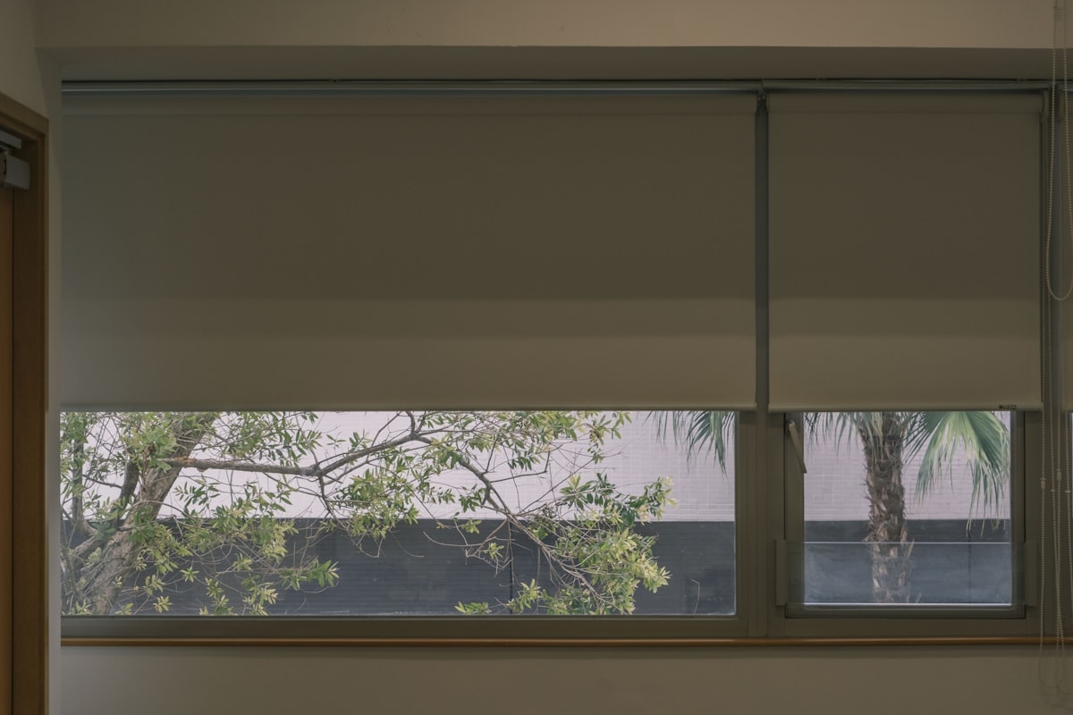 a window that has a blind in it related to Roller Shade Valances: Style and Function Combined