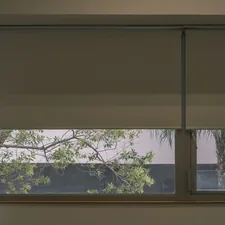 a window that has a blind in it related to Roller Shade Valances: Style and Function Combined