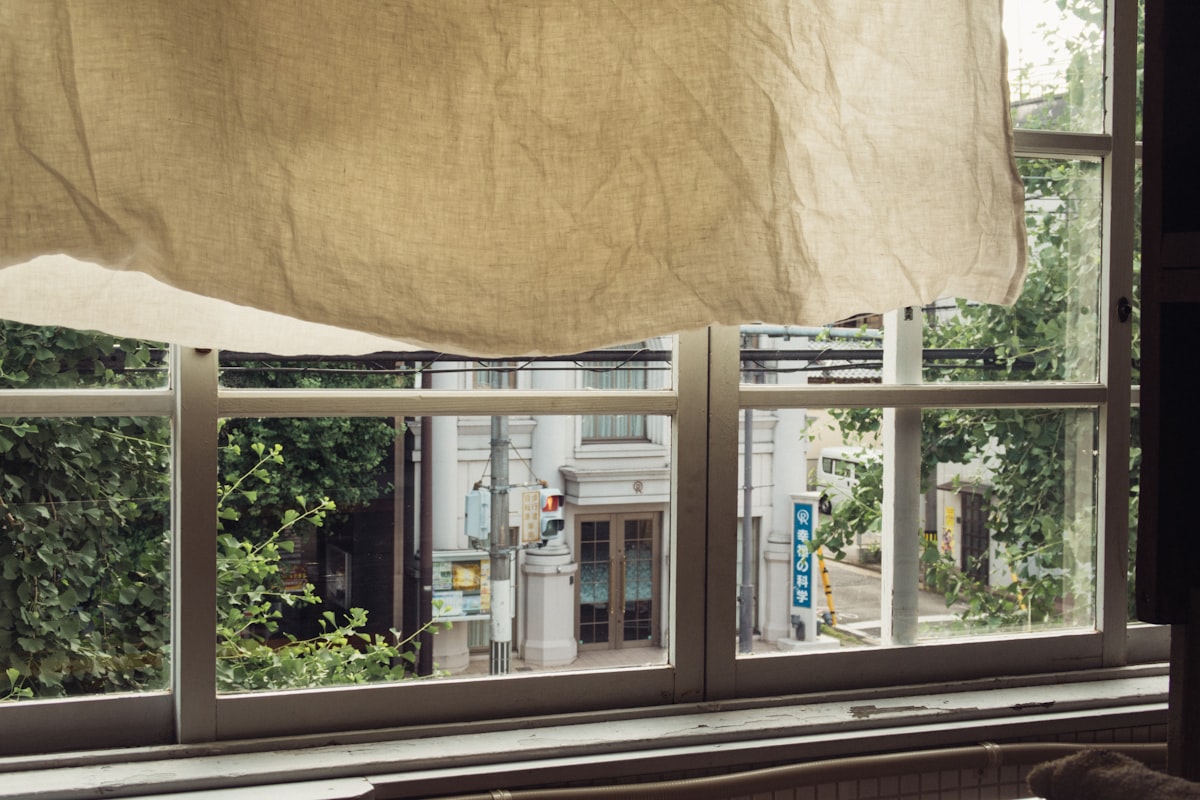 A window with a curtain hanging from it's side related to Elevate Your Window Dressing Game: A Comprehensive Guide to Valance Curtain Rods