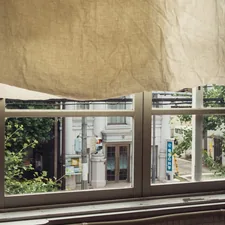 A window with a curtain hanging from it's side related to Elevate Your Window Dressing Game: A Comprehensive Guide to Valance Curtain Rods