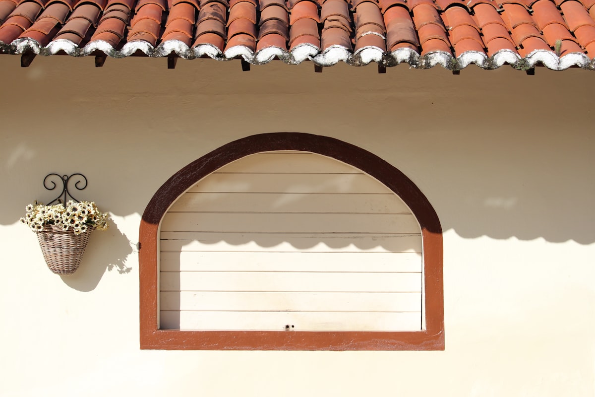 a window with a potted plant on the side of it related to Wood Window Valence Ideas