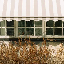 a window with a striped awning over it related to White Window Valance
