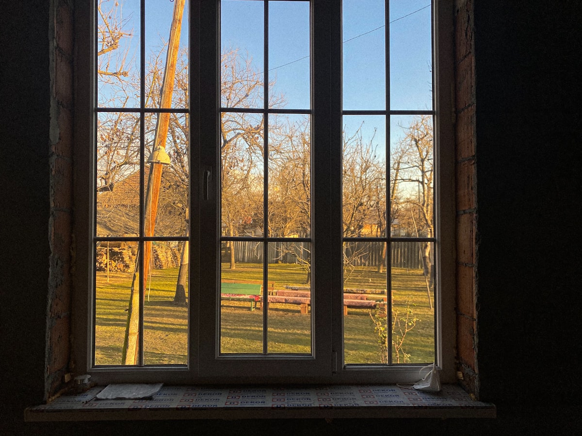 a window with a view of a field and a crane related to DIY Window Valances: Elevate Your Home Decor