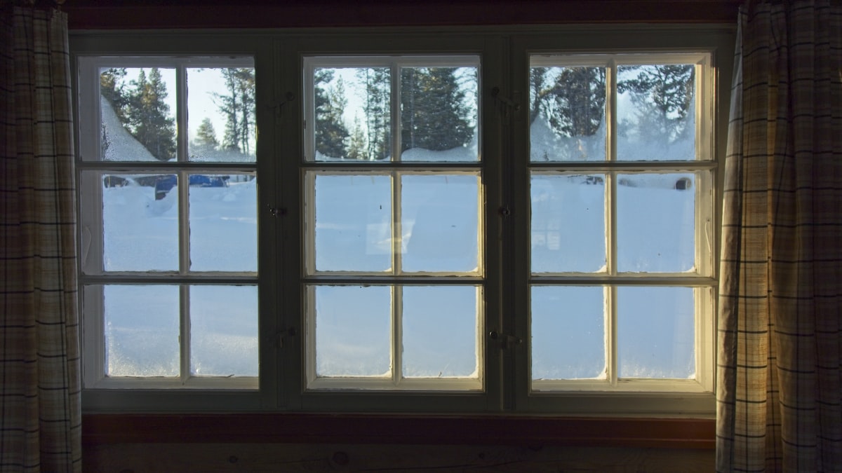 a window with a view of the snow outside related to Elevate Your Windows: The Ultimate Guide to Window Blind Valances