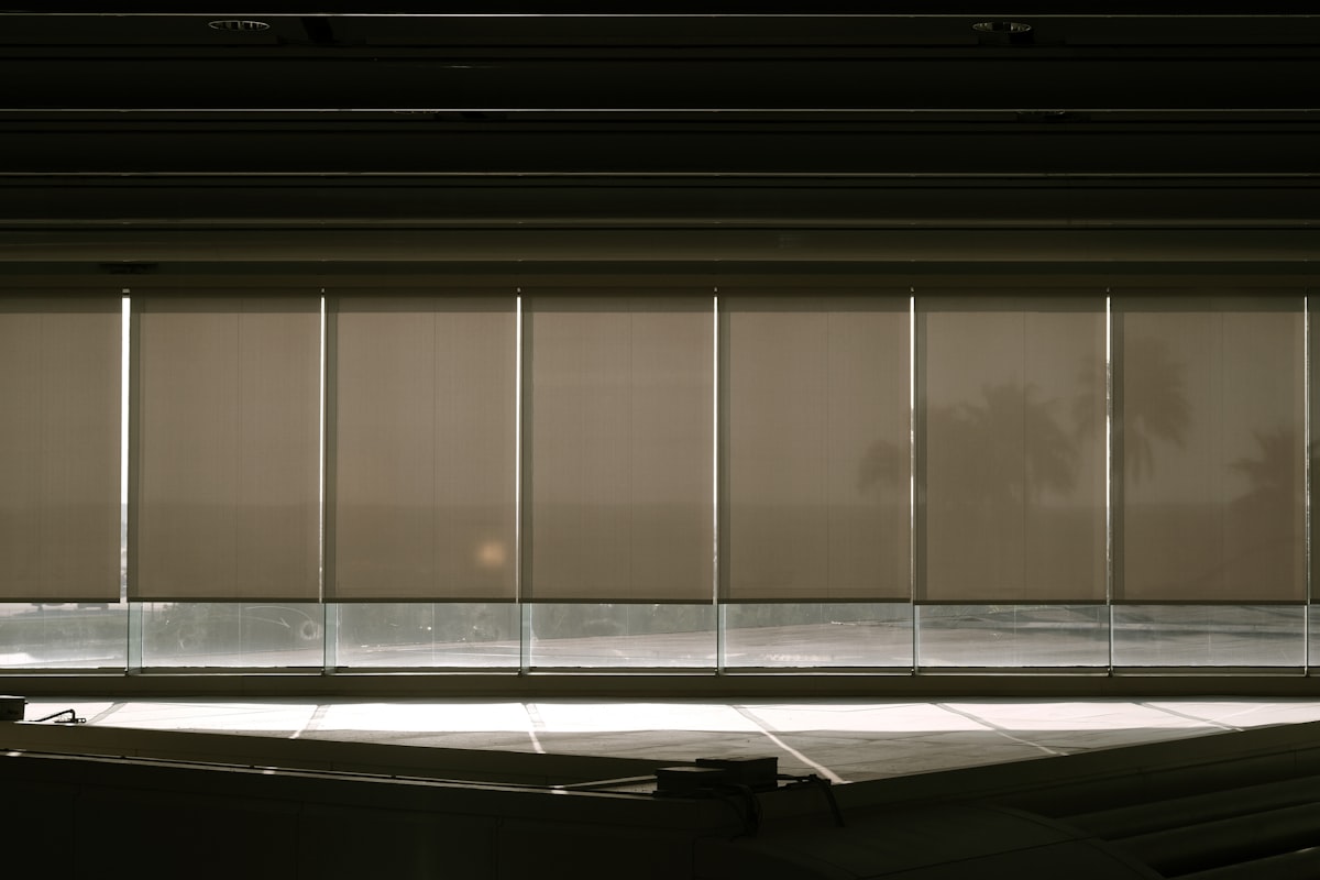 a window with blinds in a dark room related to Mastering Valance Window Treatments: A Guide to Measuring Like a Pro